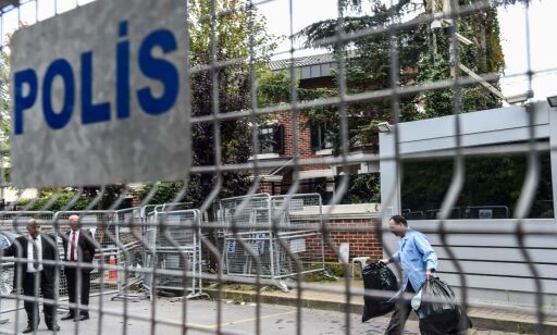 Security members of the Saudi Arabia consulate open police barriers as a cleaner carrying garbage bags walks by on October 16, 2018 after Turkish forensic police and investigation delagation left the Saudi Arabia consulate in Istanbul. - Turkey's foreign minister on October 13 accused Saudi Arabia of failing to cooperate in the probe into the disappearance of journalist Jamal Khashoggi at its consulate in Istanbul, calling on Riyadh to grant access to Turkish investigators. Khashoggi, a Washington Post contributor, vanished after entering the consulate on October 2. (Photo by BULENT KILIC / AFP)
